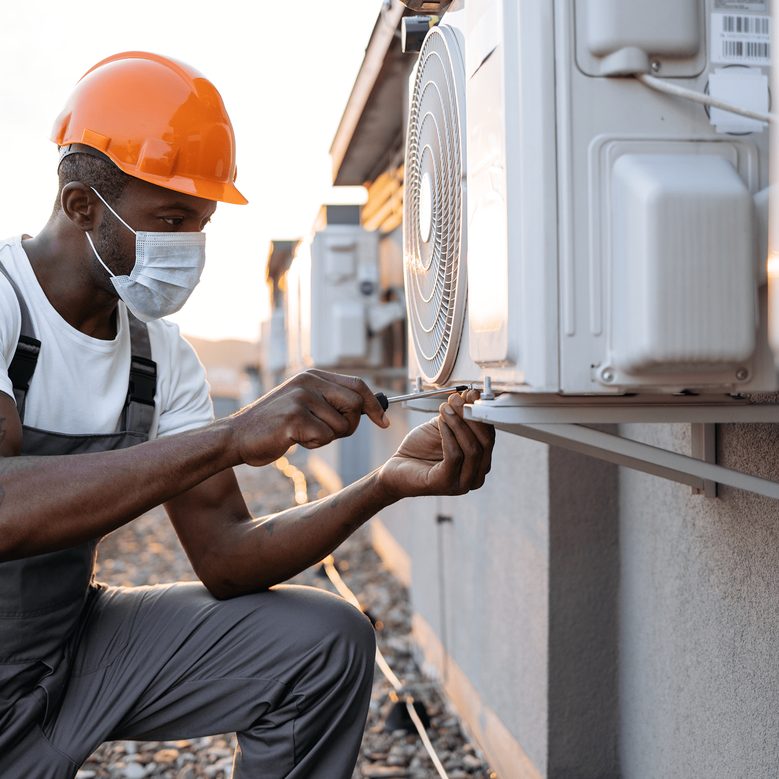 Technician fixing Air-conditioner outside unit